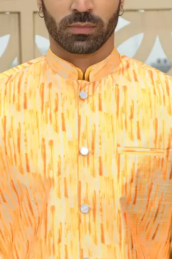 Silk blend solid yellow kurta and churidar with tie-dye yellow nehru jacket