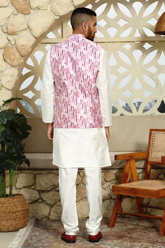 Silk blend solid cream kurta and churidar with tie-dye wine nehru jacket
