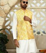 Silk blend solid cream kurta and churidar with tie-dye yellow nehru jacket