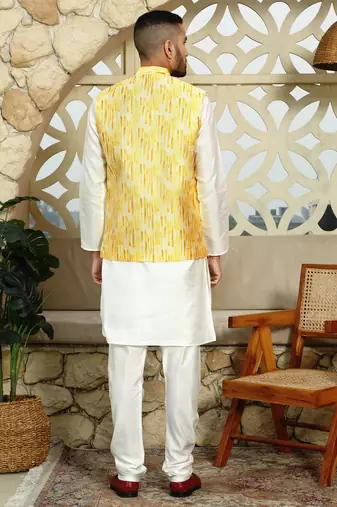 Silk blend solid cream kurta and churidar with tie-dye yellow nehru jacket