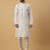 Men's cream kurta and churidar with jacquard ethnic motifs printed nehru jacket