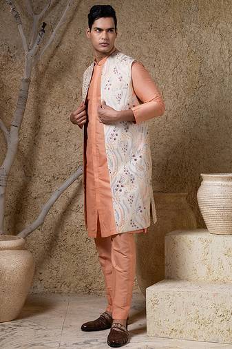 White embroidered cotton silk jacket paired with orange kurta & pant
