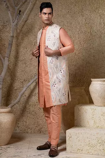 White embroidered cotton silk jacket paired with orange kurta & pant