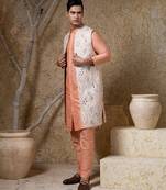 White embroidered cotton silk jacket paired with orange kurta & pant