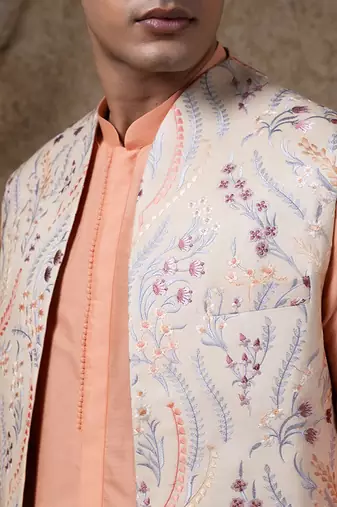 White embroidered cotton silk jacket paired with orange kurta & pant