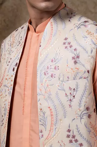 White embroidered cotton silk jacket paired with orange kurta & pant