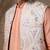 White embroidered cotton silk jacket paired with orange kurta & pant