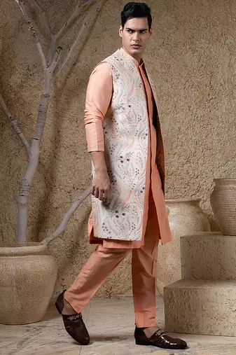 White embroidered cotton silk jacket paired with orange kurta & pant