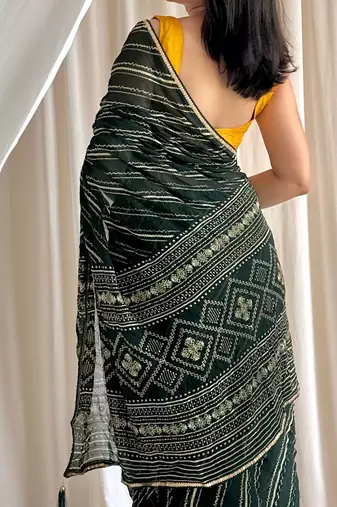 Dark green chiffon saree in leheriya with foil border work