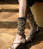 Black with long tie-up flats with gold studs.