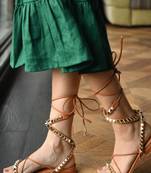 Tie-up flats with gold studs.