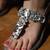 Stone embellished silver heels with ankle support strap.