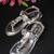 Stone embellished silver heels with ankle support strap.