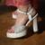 White platform block heels with silver beadwork.