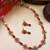 Red kemp studded sleek flower necklace set