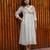 off-white cotton Kurti designed with floral embroidery and crochet lace detailing