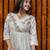 off-white cotton Kurti designed with floral embroidery and crochet lace detailing