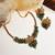 Gold plated gaj necklace set with green hydra beads