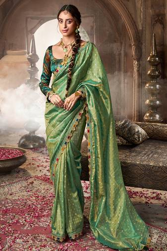 Sea green  tissue woven with multicolored lace border saree with blouse