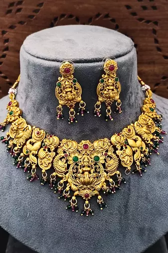 Antique gold-plated temple necklace set with lakshmi & peacock design     traditional bridal jewellery