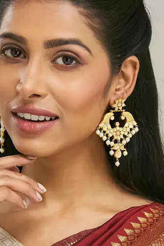 gold plated kundan and pearl earrings with floral stud and intricate crescent design chandbalis