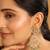 gold plated traditional kundan studded contemporary dangler earrings with pearl and green bead accents