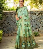 Mint green paithani silk blend saree with intricate hand woven and unstitched blouse
