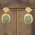 Gold plated green stone polki jhumkas in sterling silver