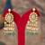 Gold plated green stone jhumkas in sterling silver