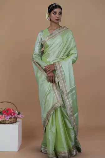 green handwoven tissue saree with matte gold lace