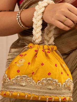 Yellow silk embroidered potli bag 1