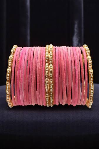 Set of 28 gold, pink velvet with metal bangle set
