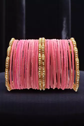 Set of 28 gold, pink velvet with metal bangle set