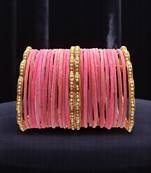 Set of 28 gold, pink velvet with metal bangle set