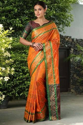 Orange patola silk blend saree with zari woven work and fancy tassel pallu