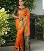 Orange patola silk blend saree with zari woven work and fancy tassel pallu