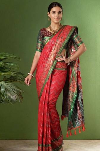 Red patola silk blend saree with zari woven work and fancy tassel pallu