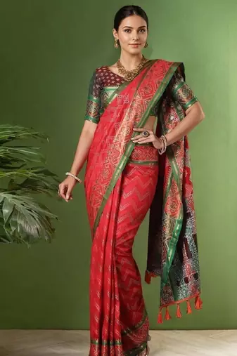 Red patola silk blend saree with zari woven work and fancy tassel pallu