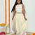 Butter yellow with carasouel print/lehenga with halter neck blouse