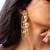High gold floral frame earrings with stone accents