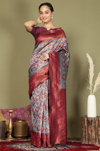 red and teal silk blend saree with rich woven pallu