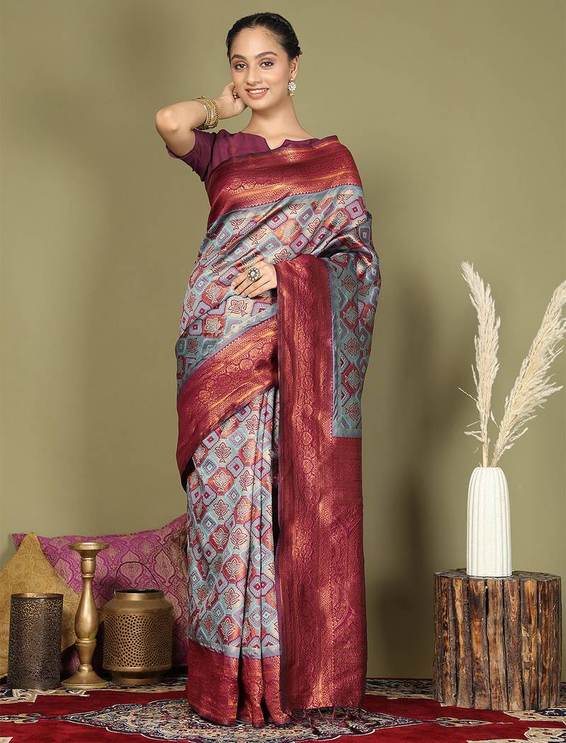 red and teal silk blend saree with rich woven pallu