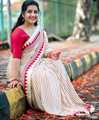 Elegant off-white saree with red stripes and geometric border 1