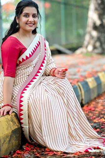 Elegant off-white saree with red stripes and geometric border