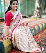 Elegant off-white saree with red stripes and geometric border