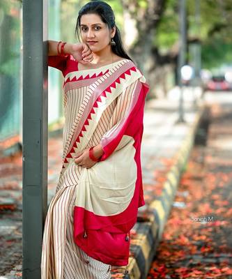 Elegant off-white saree with red stripes and geometric border 2