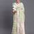 cream linen cotton saree with light green pallu and contrast blouse piece