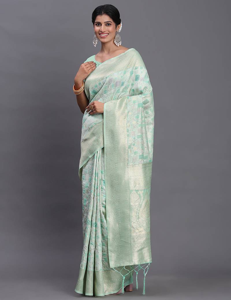 Sea green linen cotton saree with silver zari weave and tassels