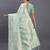 Sea green linen cotton saree with silver zari weave and tassels