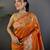 Orange silk blend floral zari weaving meenakari saree with floral border